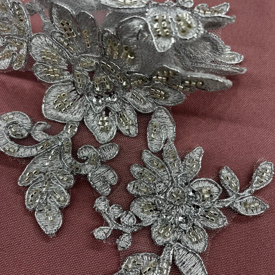 Beaded & Corded Silver Floral Appliqué Lace Embroidered on 100% Polyester Organza or Net Mesh. This can be applied to Theatrical dance ballroom costumes, bridal dresses, bridal headbands endless possibilities. Sold By Pair. Lace Usa