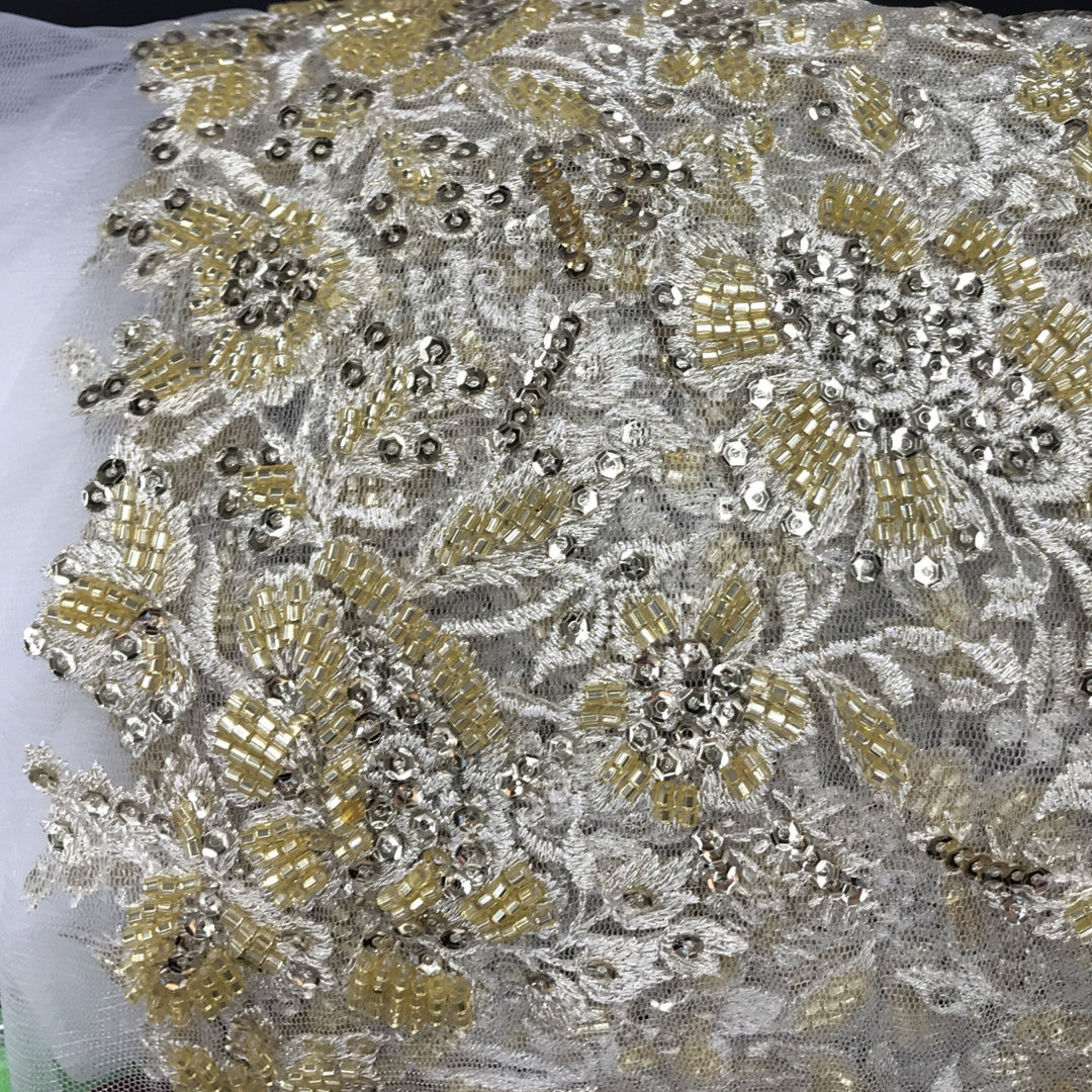 Embroidered & Heavily Beaded Fabric on net.  Sold by the yard.  Lace Usa