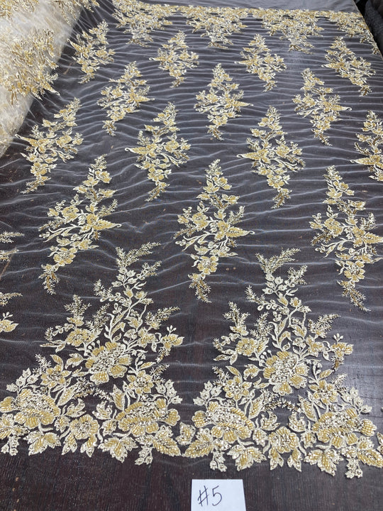 Embroidered & Heavily Beaded Fabric on net.  Sold by the yard.  Lace Usa