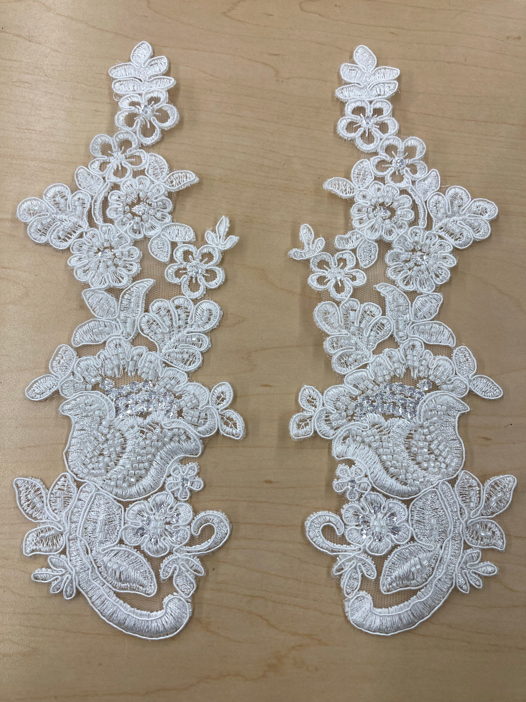 Beaded & Corded Floral Ivory Appliqué Lace Embroidered on 100% Polyester Mesh Net. This can be applied to lyrical dance ballroom costumes, bridal dresses, bridal headbands endless possibilities.  Sold By Pair  Lace Usa